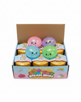 Squishy Steam Bunz glitter display box with 4 glitter squishy dumplings in pink, purple, blue and green on white background
