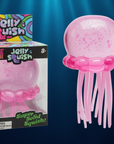 Nee Doh Jelly Squish pink glitter jellyfish toy in packaging and out of packaging on deep navy ocean background