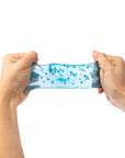 Hands stretching a blue and white textured band against a white background