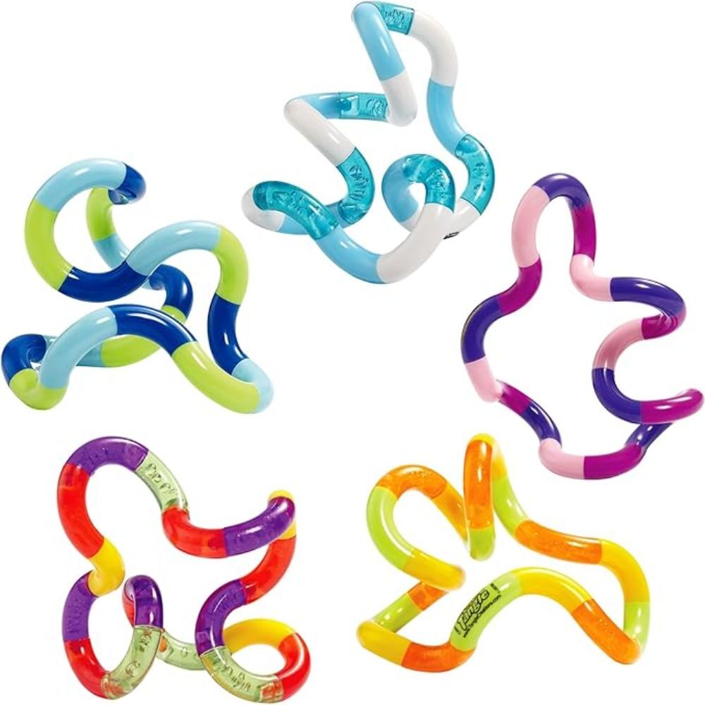 Colorful plastic toys shaped like intertwined rings on a white background