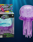 Nee Doh Jelly Squish purple glitter jellyfish toy in packaging and out of packaging on deep navy ocean background