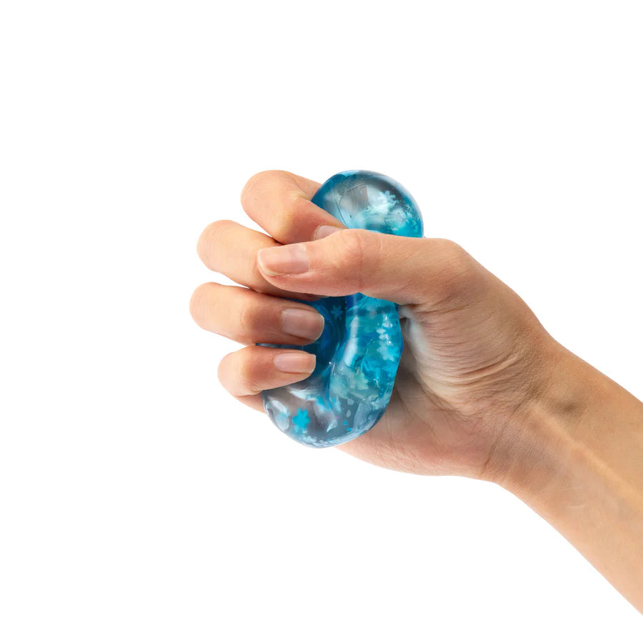 Hand holding a blue stress ball against a white background