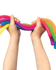 Colorful stretchy toy held by hands on a white background